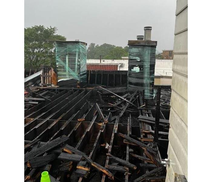 A picture containing the rooftop of a commercial building in Washington, DC affected by fire damage